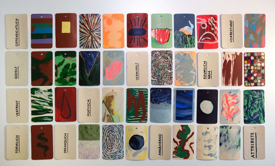 enlarge the image: Multicoloured cards and cards with attributes lie next to each other.