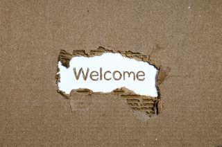 The word "welcome" in a cardboard background.